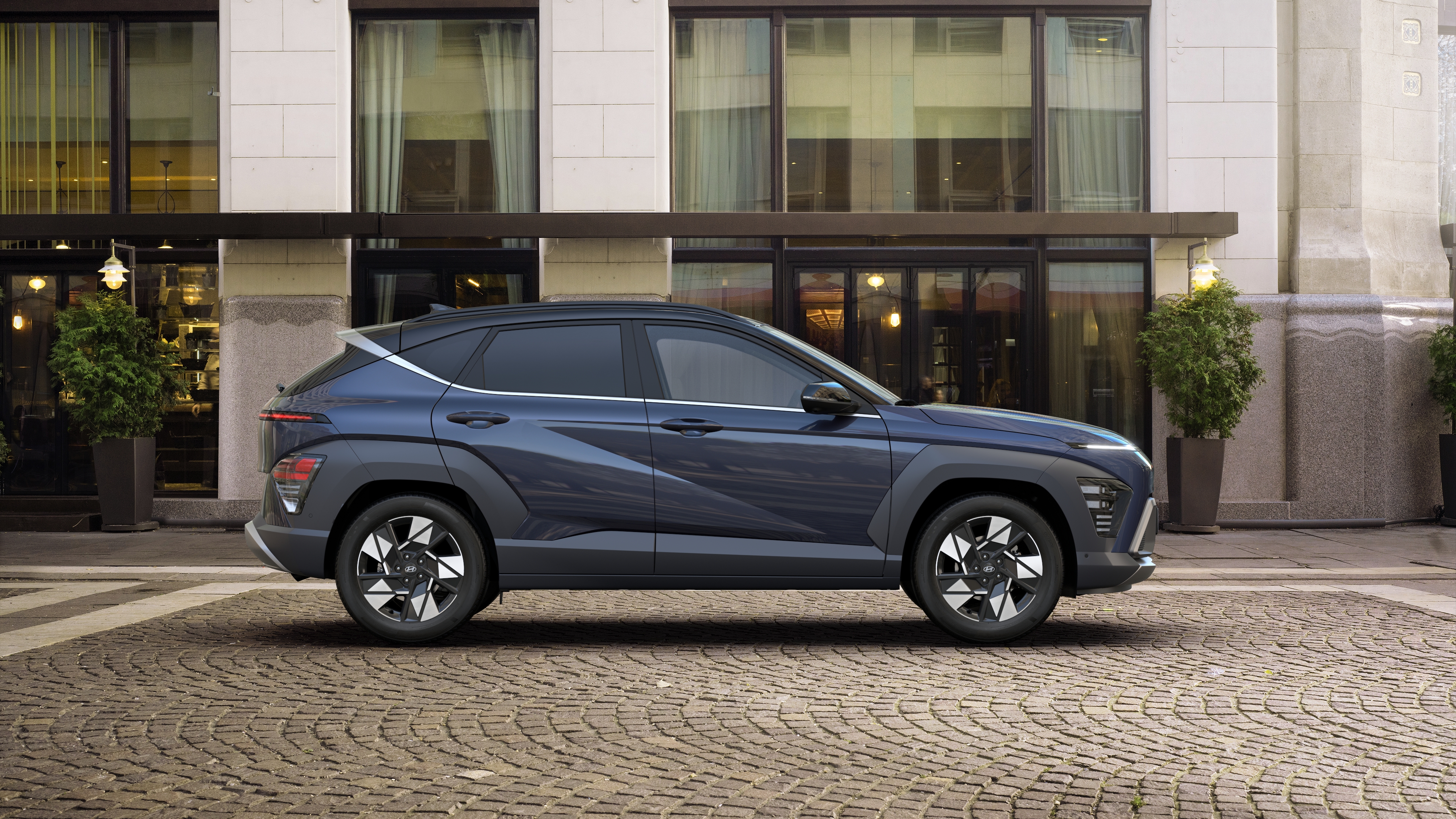 	 The all-new Hyundai KONA Hybrid pictured from the side showing one of its wheels.