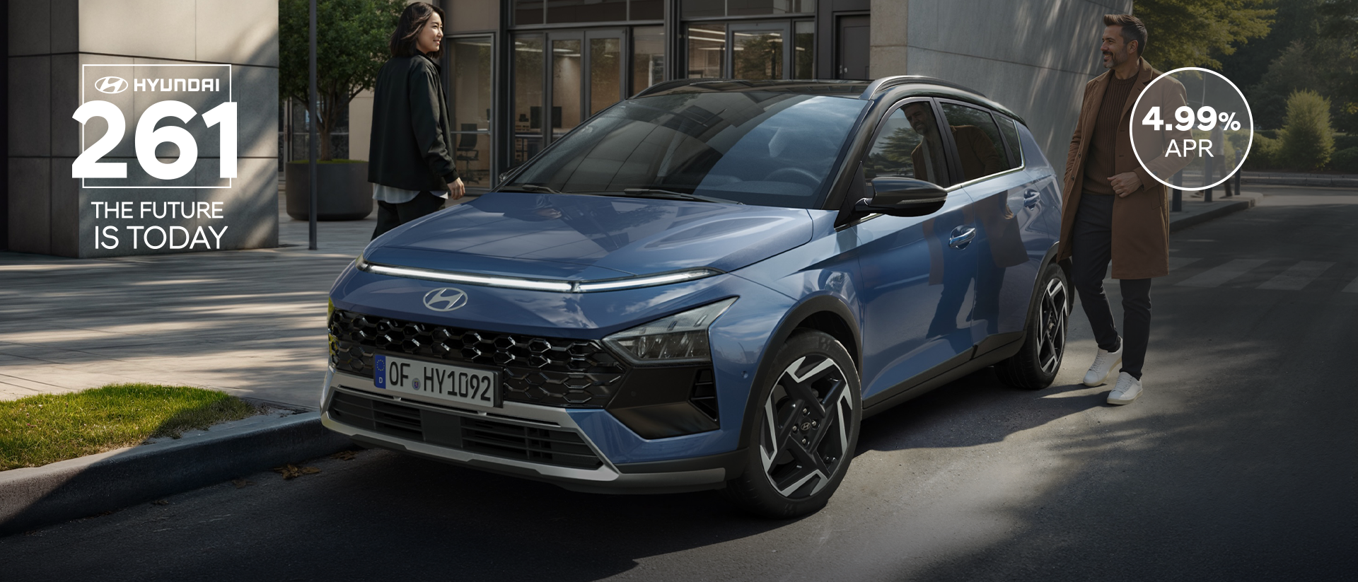 The new Hyundai BAYON is seen the front, with urban housing in the background.