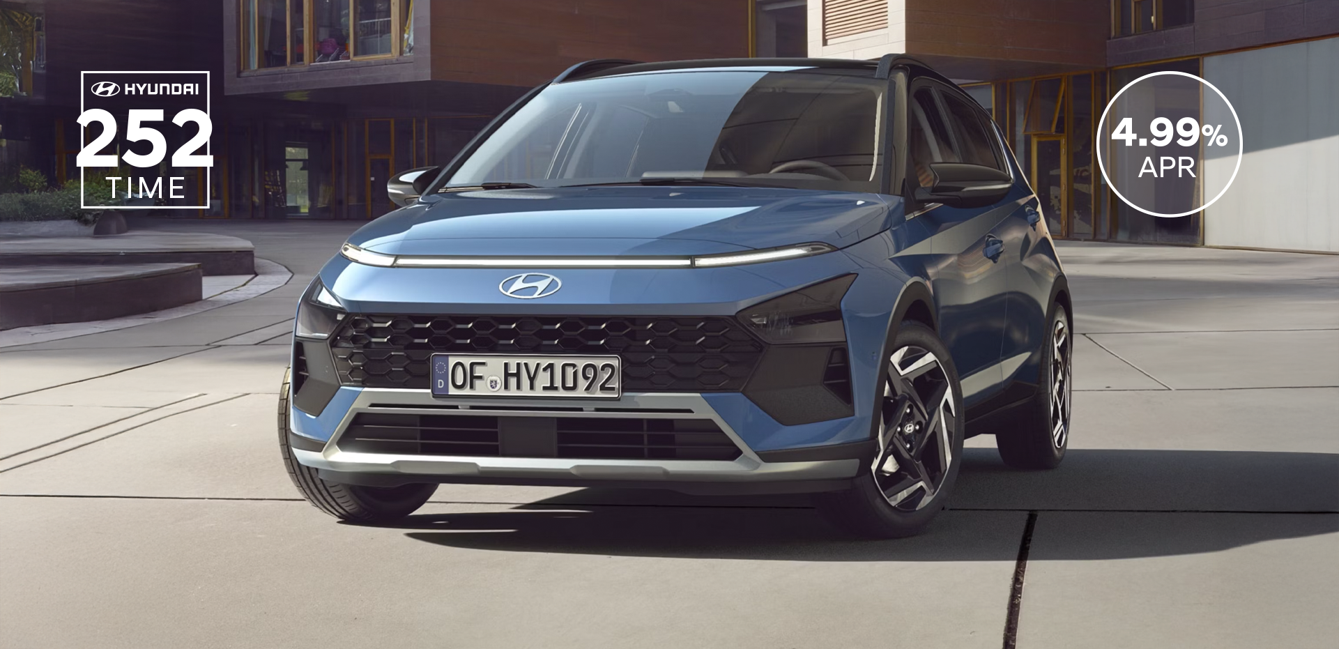 The new Hyundai BAYON is seen the front, with urban housing in the background.