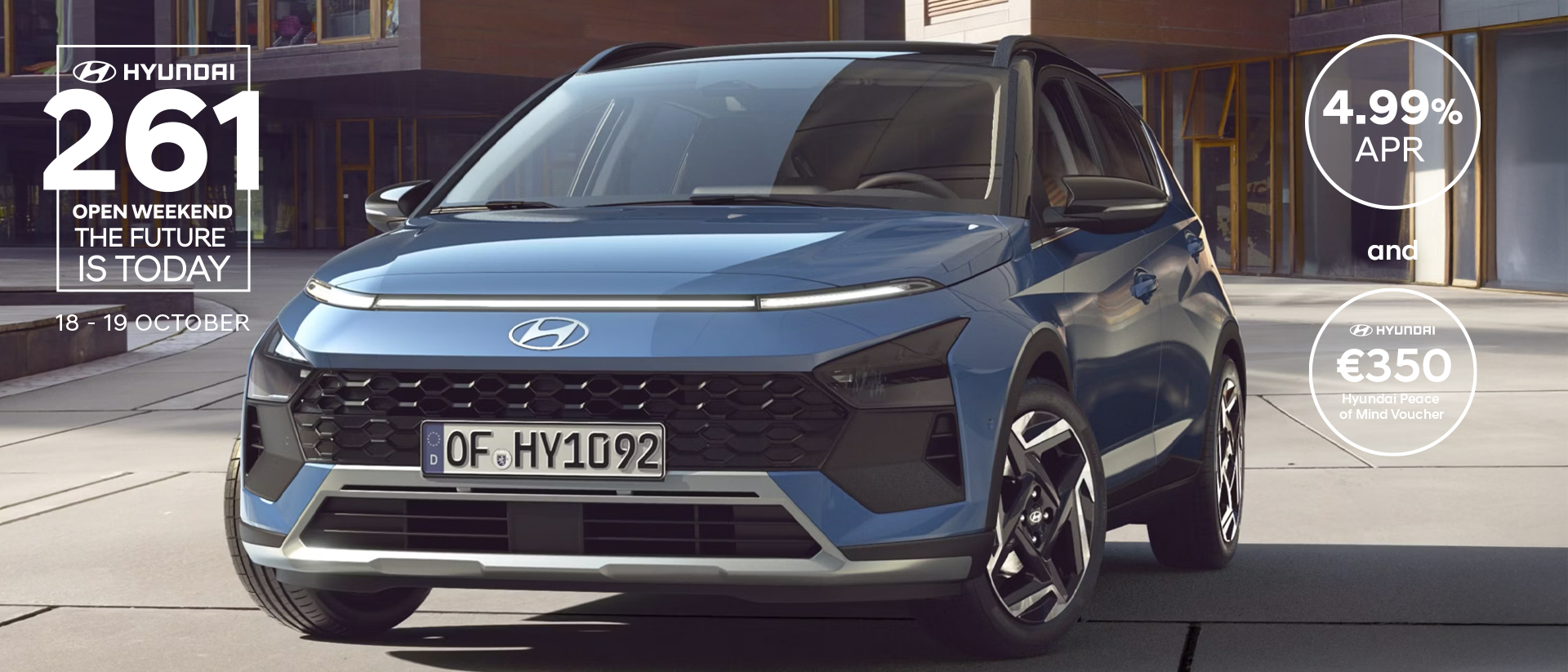 The new Hyundai BAYON is seen the front, with urban housing in the background.