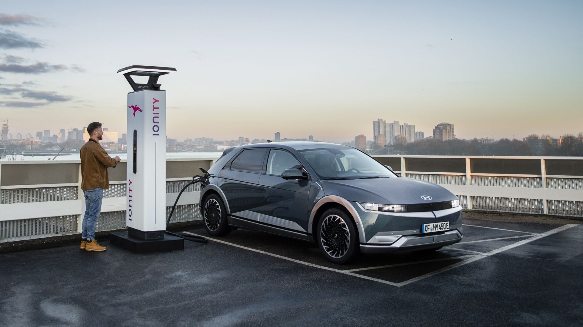 The Hyundai IONIQ 5 electric vehicle charging at an IONITY charging station on a rooftop.