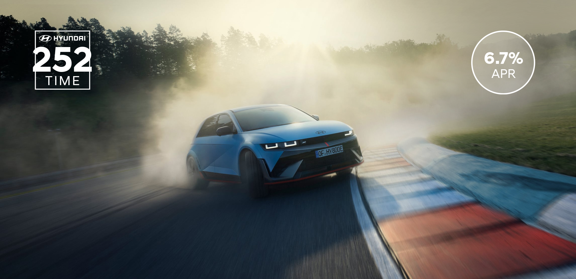 The all-electric Hyundai IONIQ 5 N drifting through a curve on a racetrack with smoking tyres.