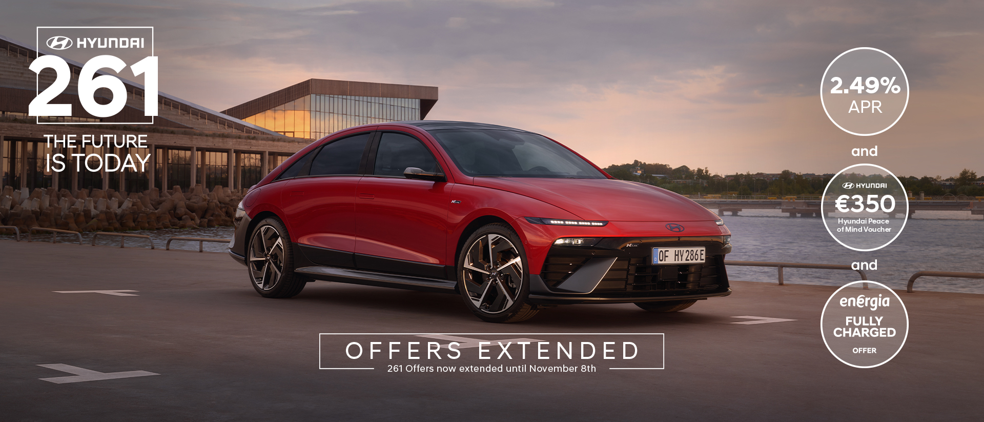 The all-electric Hyundai IONIQ 6 charging in a city with a man leaning on it with an ice cream.