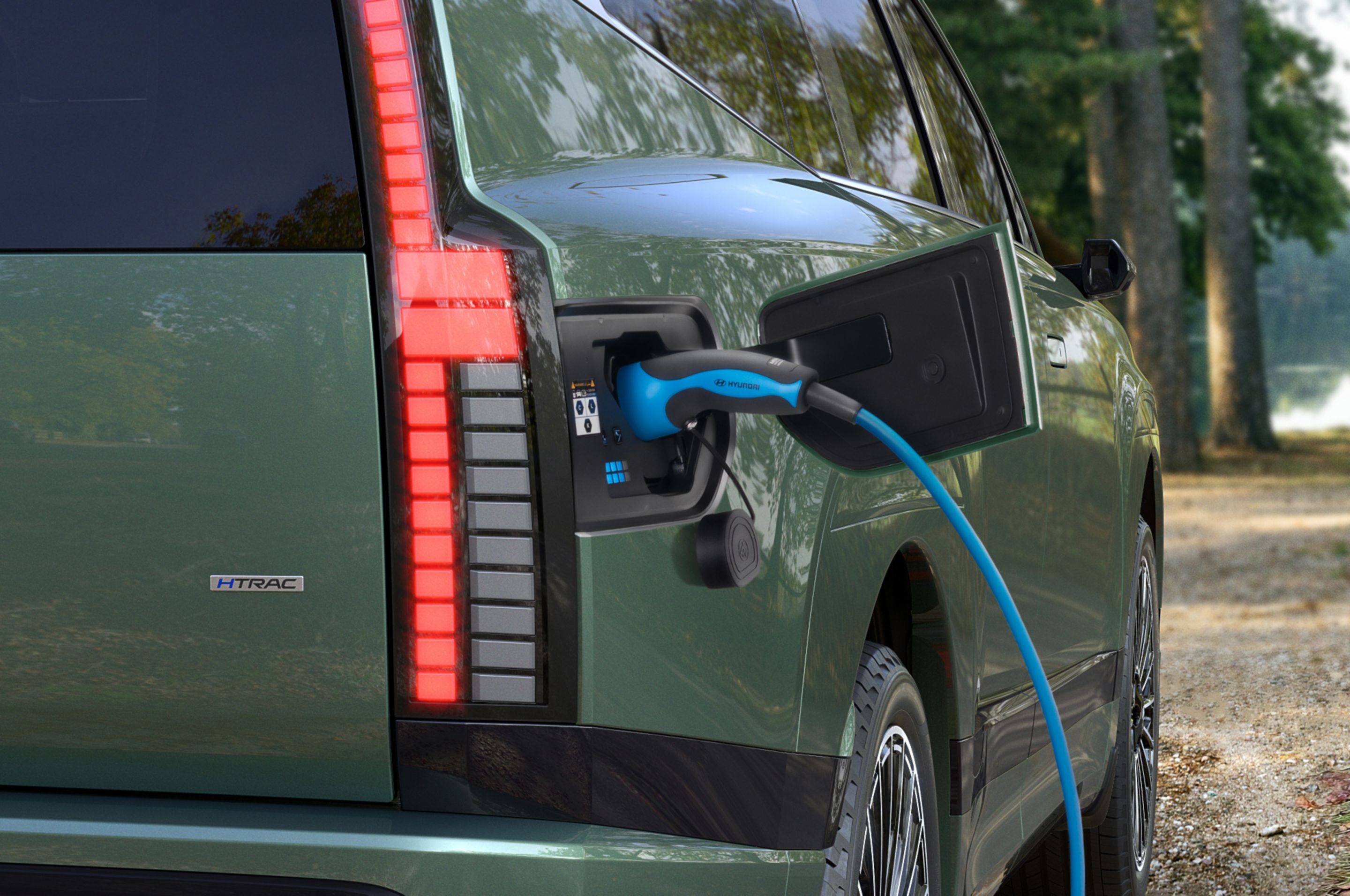 The open charging socket of Hyundai IONIQ 9 electric SUV with charging cable.