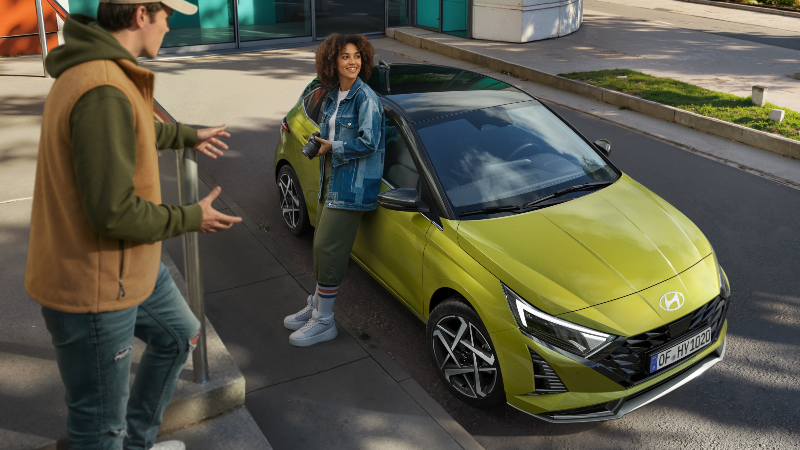 A backseat perspective of the driving wheel and dashboard of the Hyundai i20.