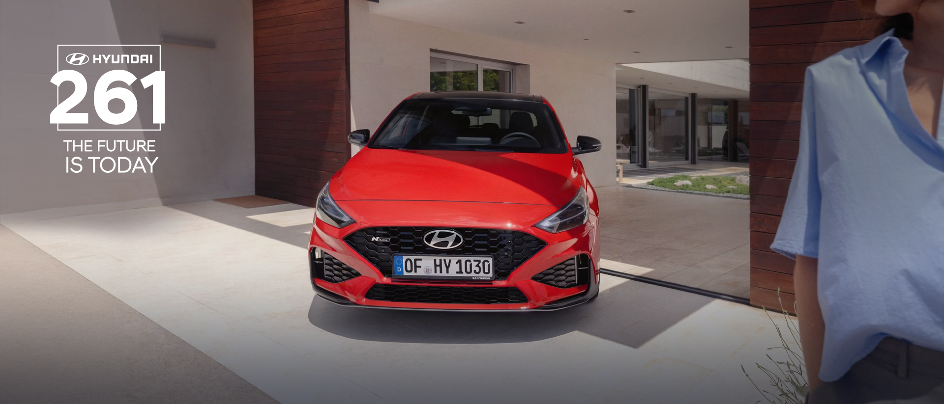 The new Hyundai i30 N Line in red parked in front of the house.