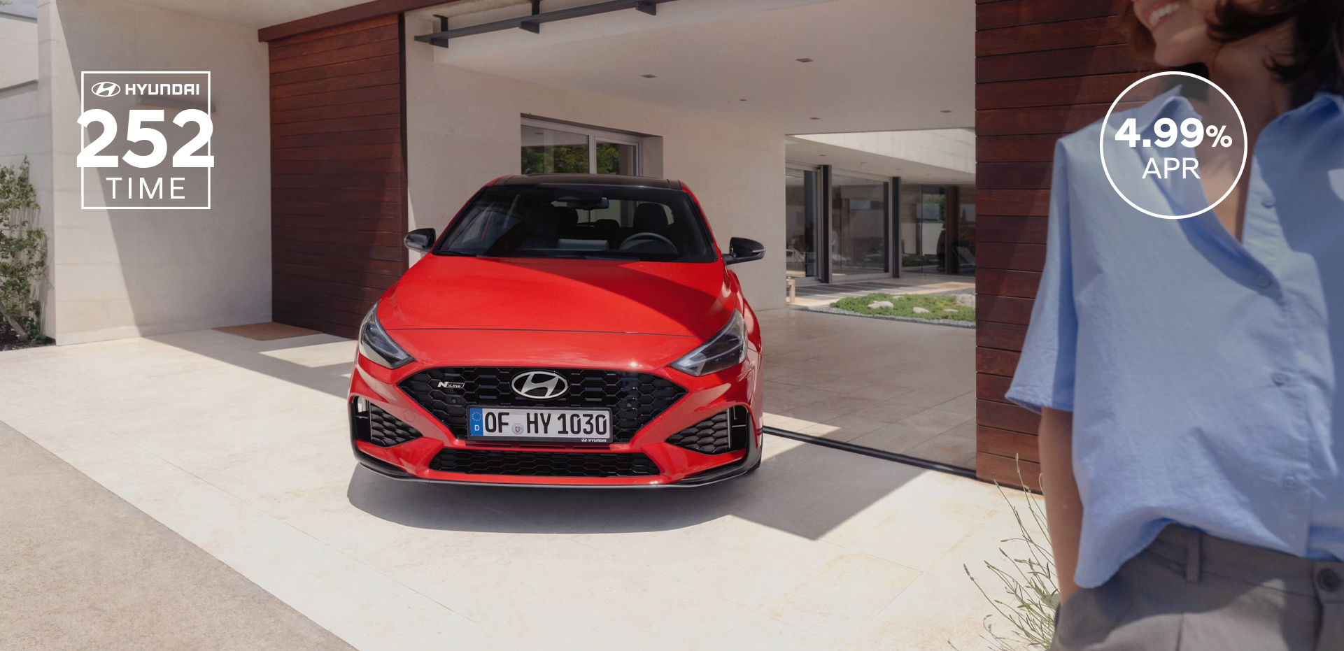 The new Hyundai i30 N Line in red parked in front of the house.