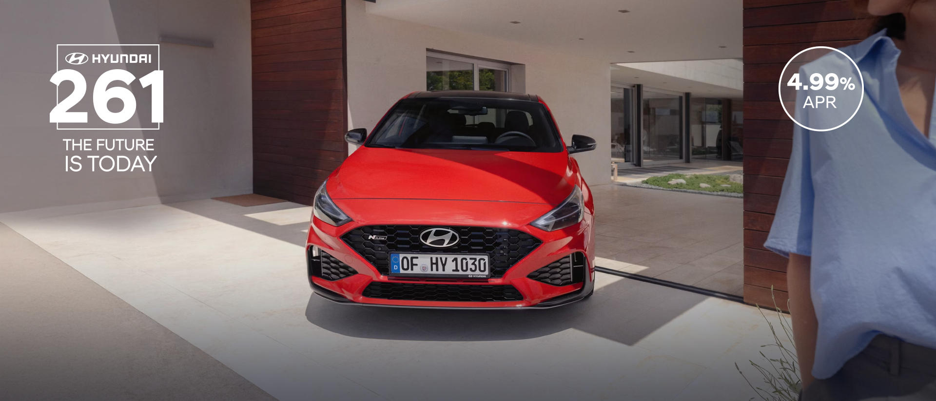 The new Hyundai i30 N Line in red parked in front of the house.