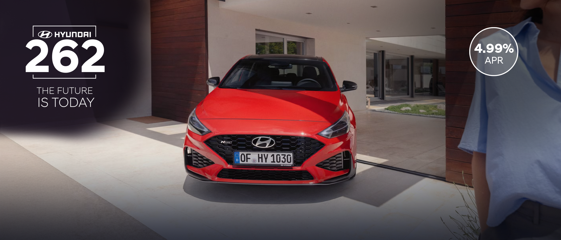 The new Hyundai i30 N Line in red parked in front of the house.