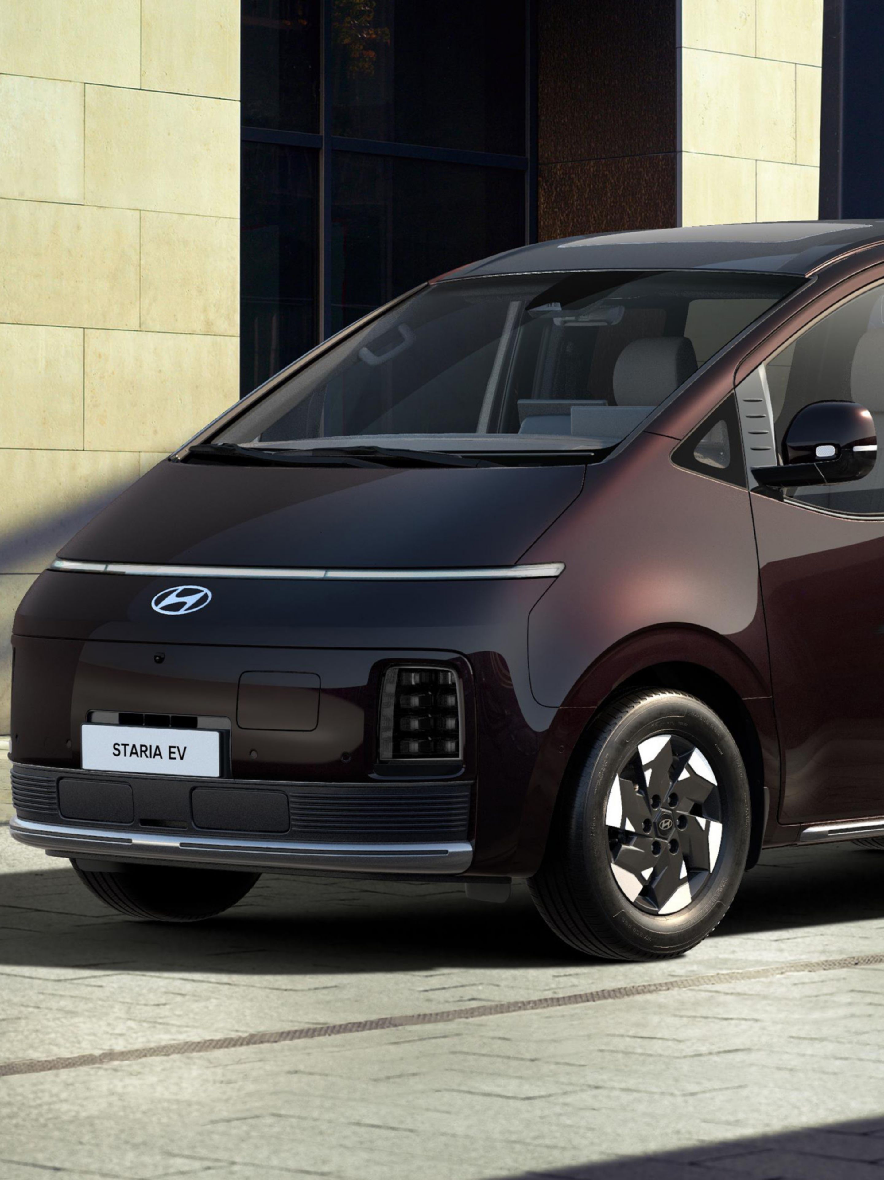 Front three-quarter view of a parked Hyundai STARIA Electric.