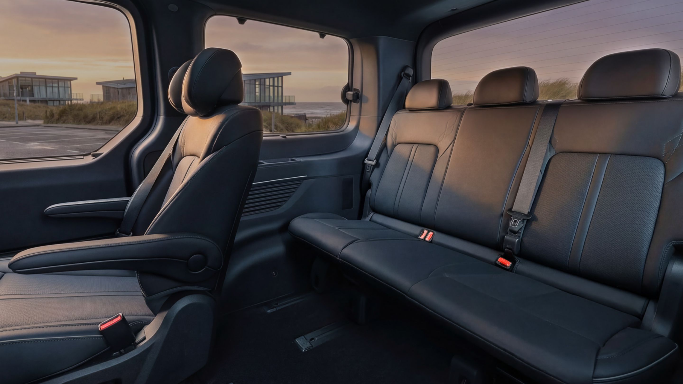 Hyundai STARIA Electric front seating area with multifunction center console and adjustable armrests.