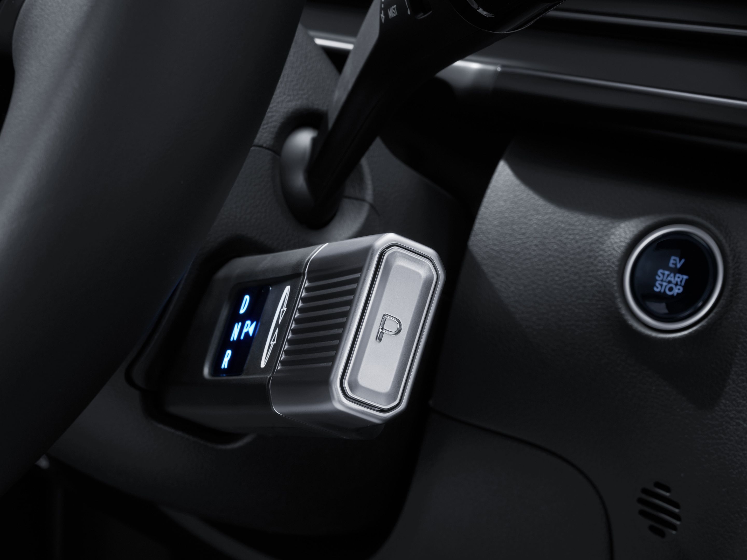 Close-up of the Hyundai STARIA Electric column-type Shift-by-Wire selector with illuminated gear display and integrated Park button