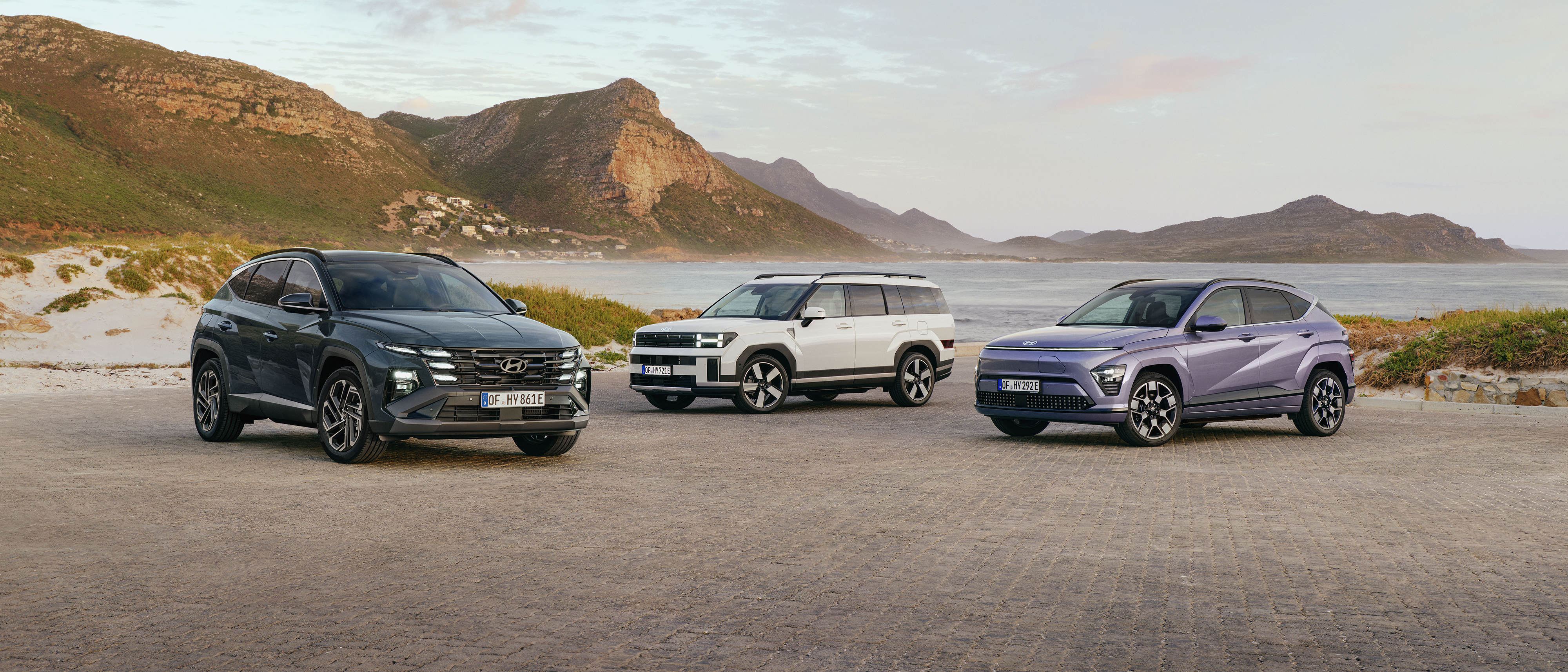 Hyundai Tucson, Kona and Santa FE standing together next to shore